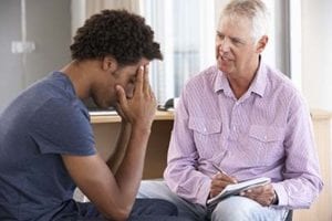 a therapist and his patient in a cognitive behavioral therapy program