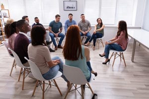 a group sitting at a dialectical behavior therapy program
