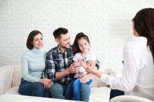 parents and their child at a family therapy program