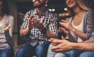 people clapping together at a group therapy program