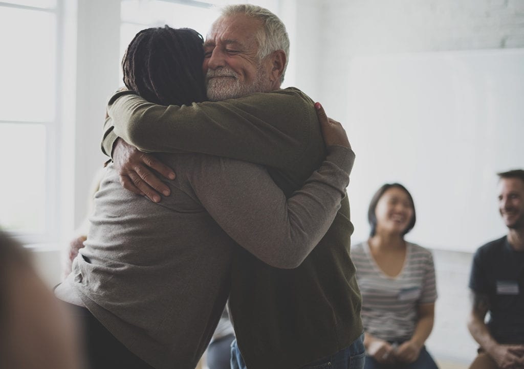 a man hugging a woman who is healing from shame and addiction