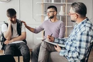 men comforting each other at a mens rehab program