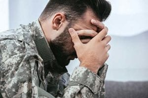 a man in an army uniform searching for a ptsd treatment center