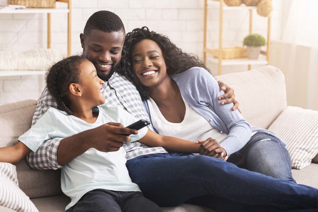 family hugging on couch knowing the stages of addiction recovery