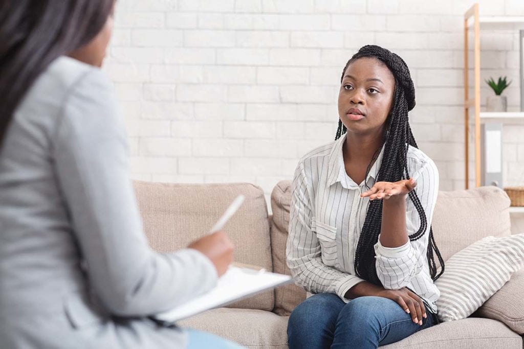 woman on couch asking therapist what is psychotherapy