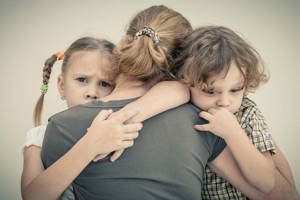 children sad being hugged by mother how addiction affects families