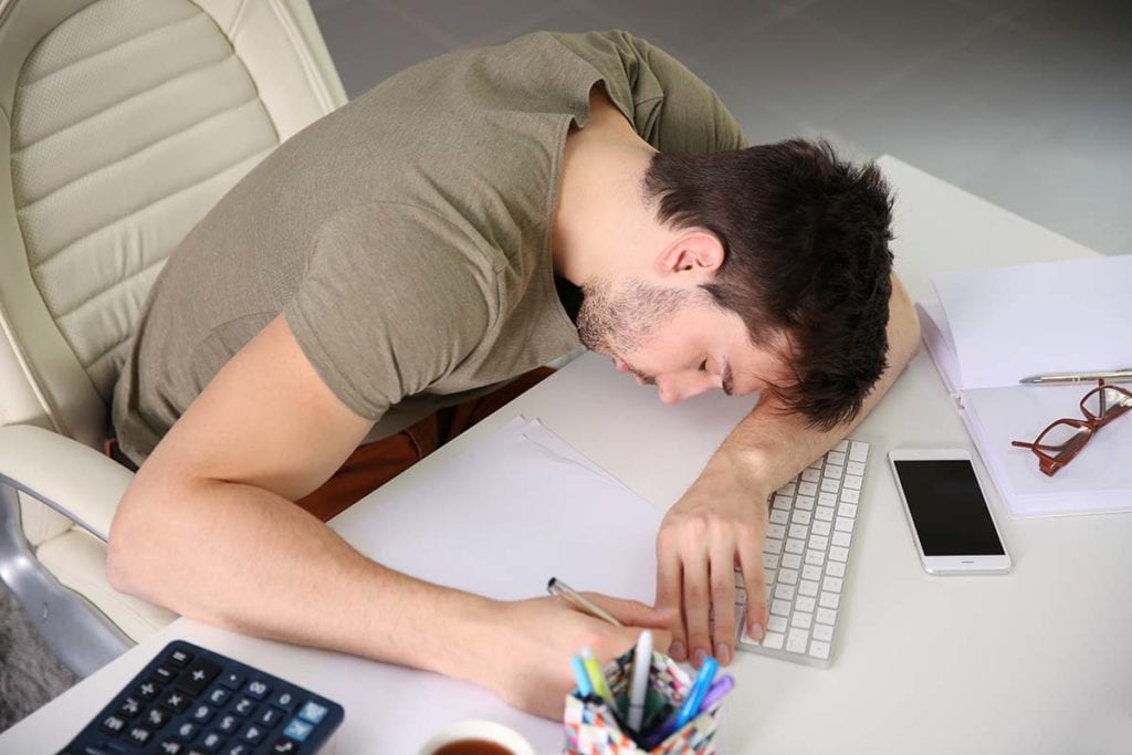 man asleep at keyboard due to marijuana and education