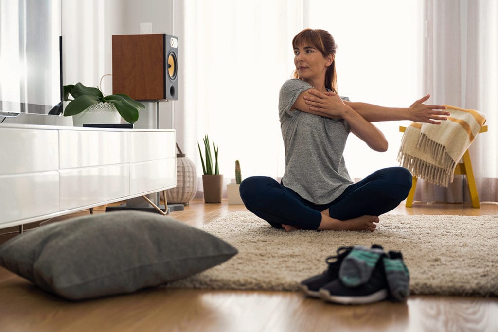 woman stretching coping with isolation during coronavirus