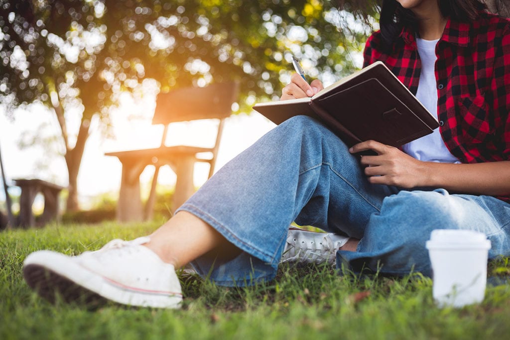 woman reading Relapse Prevention Techniques outside