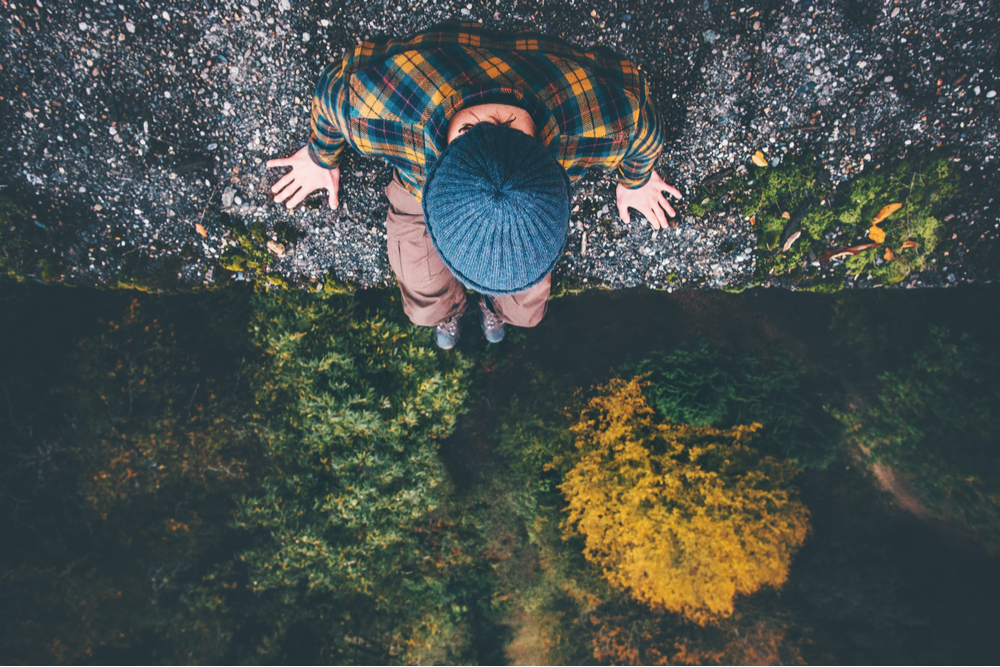 Man on a cliff in need of mental health treatment