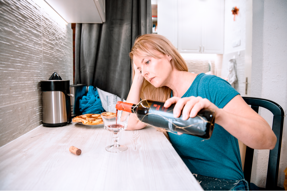 Woman with anxiety and depression drinking wine dealing with how alcohol impacts anxiety and depression