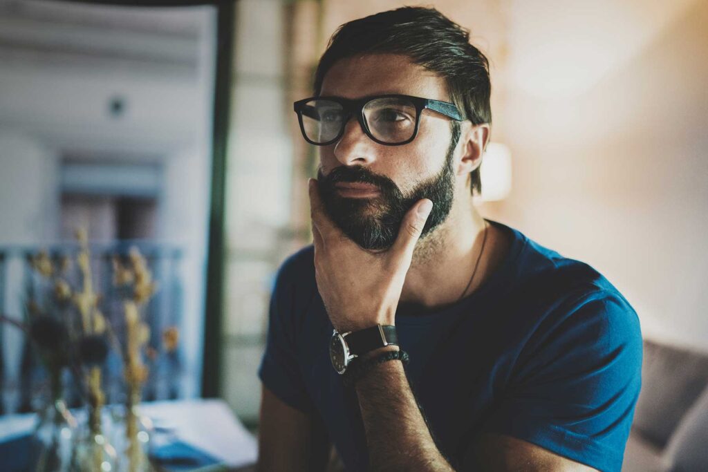 Man stroking his chin, thinking about moral inventory examples