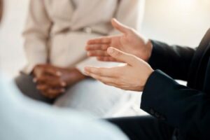 Hands of two people in a residential treatment program