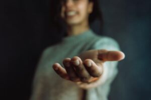 Person with hand outstretched at a cocaine rehab program