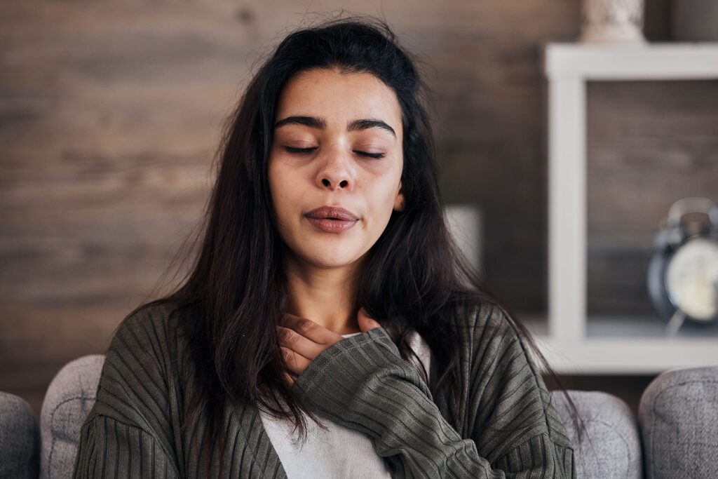 Person with closed eyes, internalizing what grounding techniques are