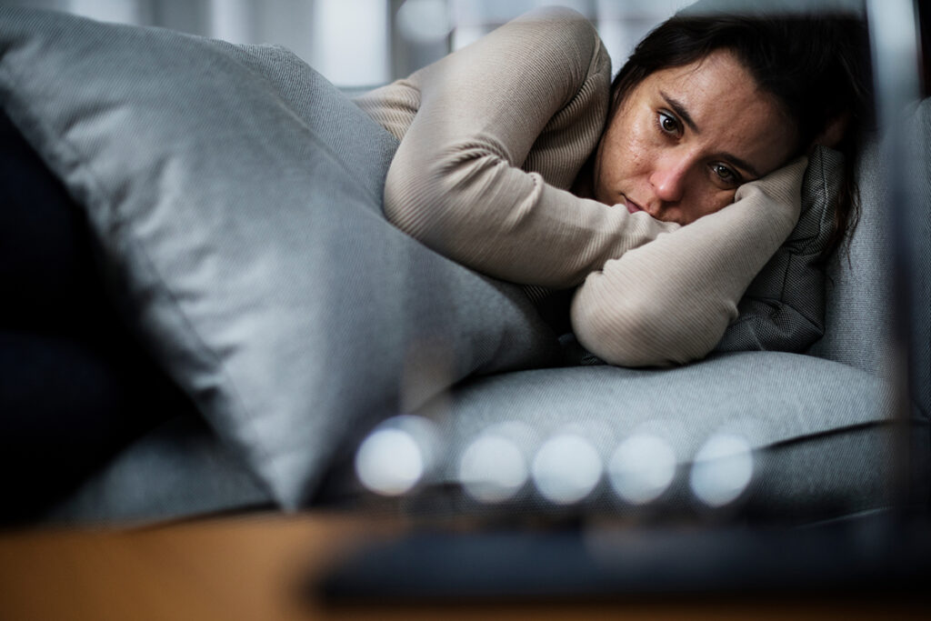 Person lying down on their side and experiencing symptoms of synthetic marijuana withdrawal