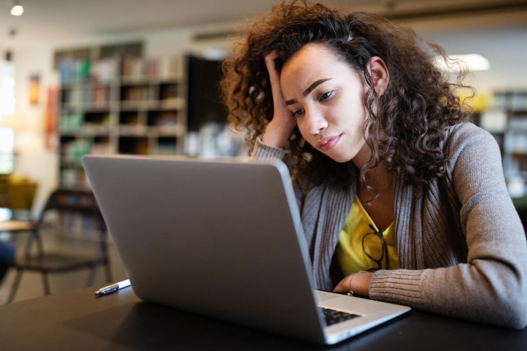 Person learning about the signs of ADHD in adults while using their laptop